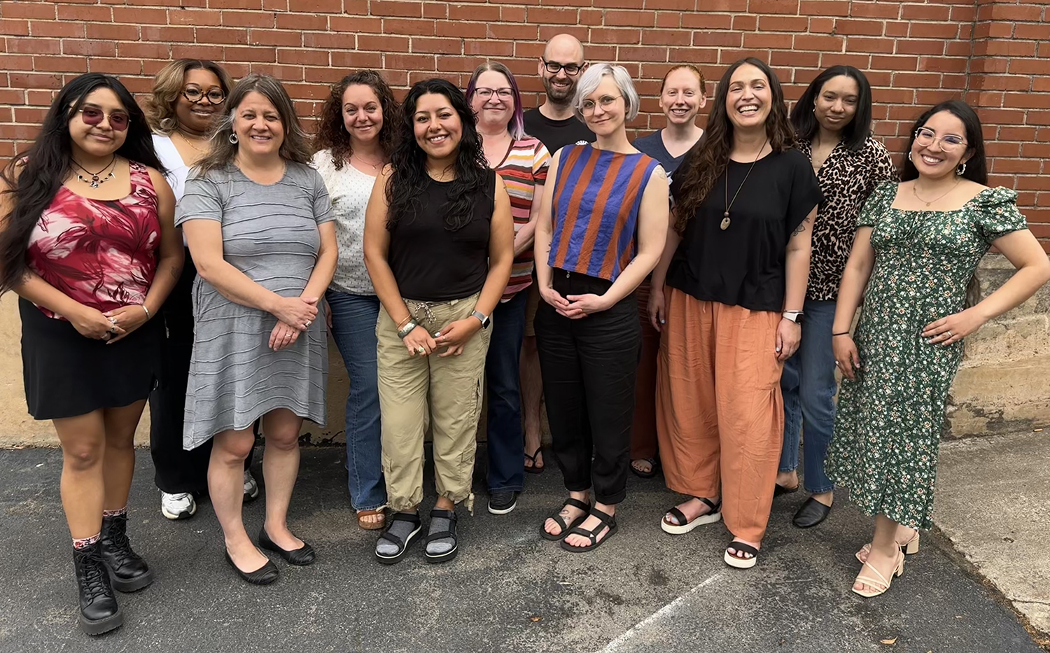 A photo of the members of the Budget & Tax Center team. there are 12 people in the photo, which was taken outside.